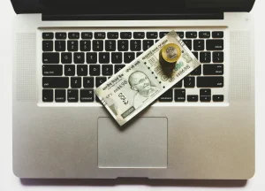 Indian currency on laptop keyboard representing online earning, digital payments, or making money online in India.